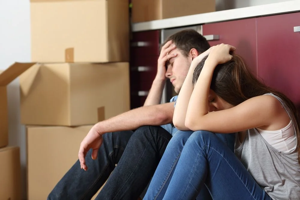 Family with moving boxes facing eviction after foreclosure